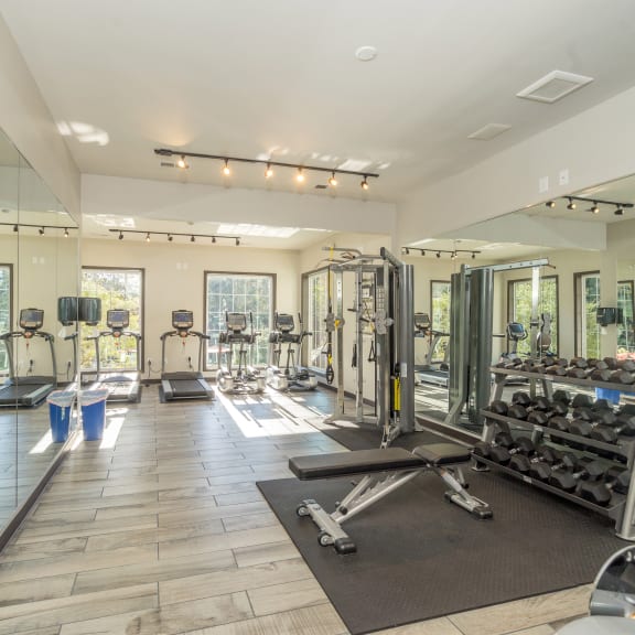 a gym with cardio equipment and mirrors on the wall at Radbourne Lake Apartments, Charlotte, 28269