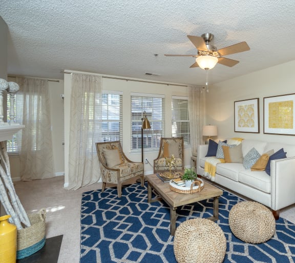 a living room with a ceiling fan and a white couch at Radbourne Lake Apartments, Charlotte, NC 28269