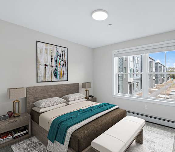 A bedroom with a large bed and a window overlooking a street.