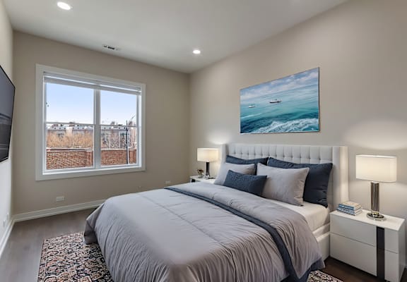 a master bedroom with a large bed and a window