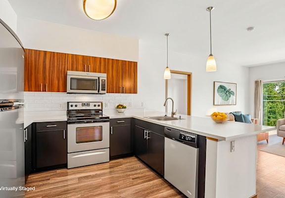 A modern kitchen with a wooden backsplash and stainless steel appliances.