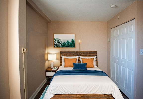 a bedroom with a large bed and a closet