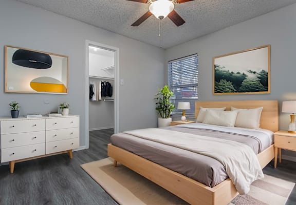a bedroom with a bed and a ceiling fan