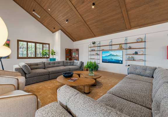 A living room with a grey couch and a wooden coffee table. at The Teale New Haven Apartments, Melbourne, FL, 32904