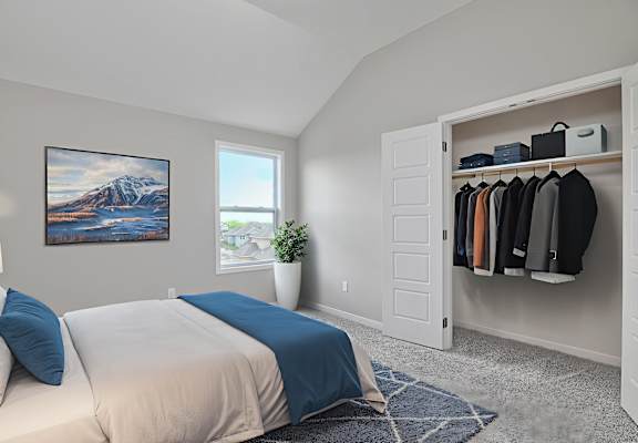 A bedroom with a large bed and a painting on the wall.