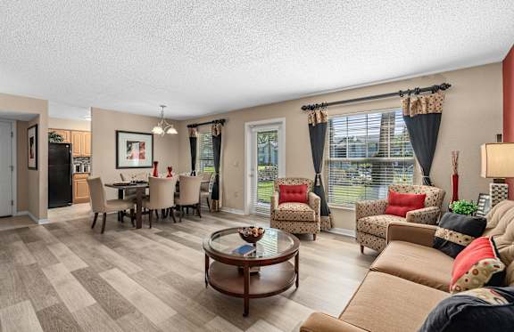 a living room with a couch and a television at Oak Reserve at Winter Park, Winter Park