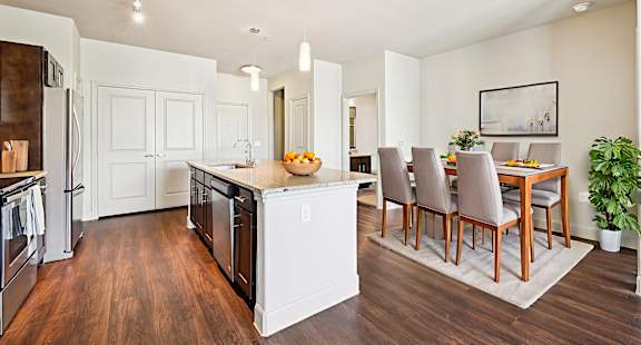 A kitchen with a dining table and chairs.at North Creek, Hutto, TX, 78634