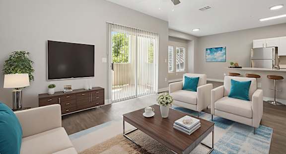 A living room with a white couch, a wooden coffee table, and a flat screen TV.
