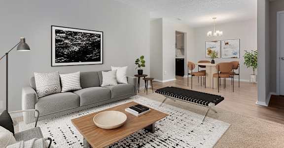 a living room with a gray couch and a wooden coffee table