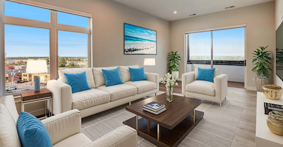 a living room with couches and chairs and a table