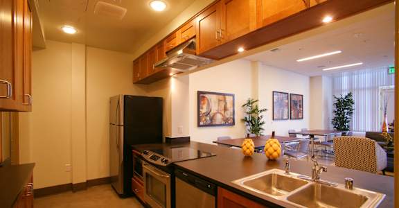 a kitchen with a sink and a stove and a refrigerator