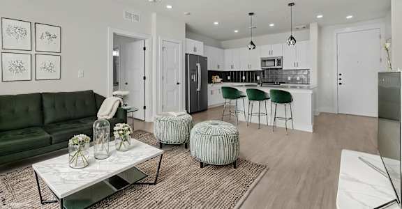 A modern living room with a green sofa and a coffee table.