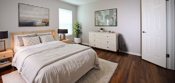 a bedroom with a large bed and a ceiling fan