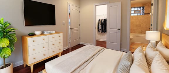 a master bedroom with a large bed and a tv
