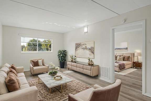 a living room with a couch and a ceiling fan