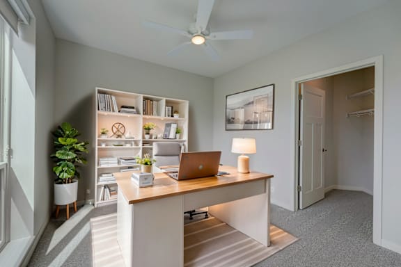 a home office with a desk and a laptop