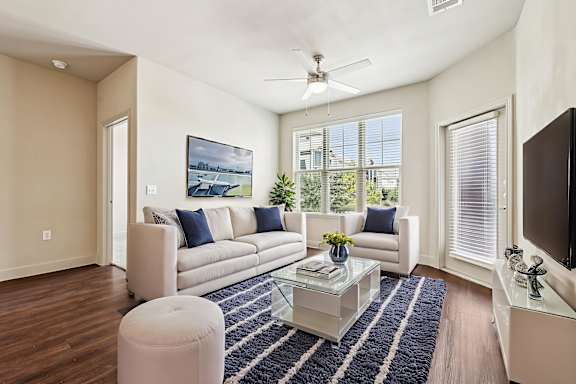A living room with a white couch and a blue and white rug.at North Creek, Hutto, TX, 78634
