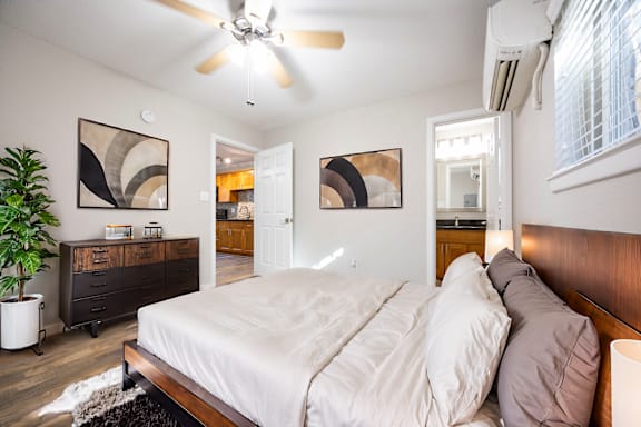 a bedroom with a large bed and a ceiling fan
