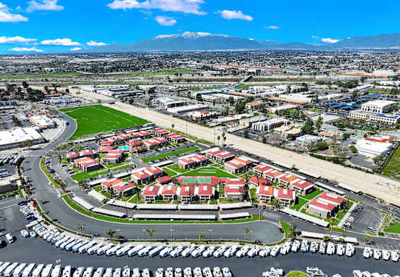 A large parking lot is in the foreground of a cityscape.