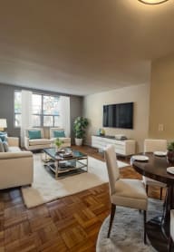 a living room with a table and chairs and a couch