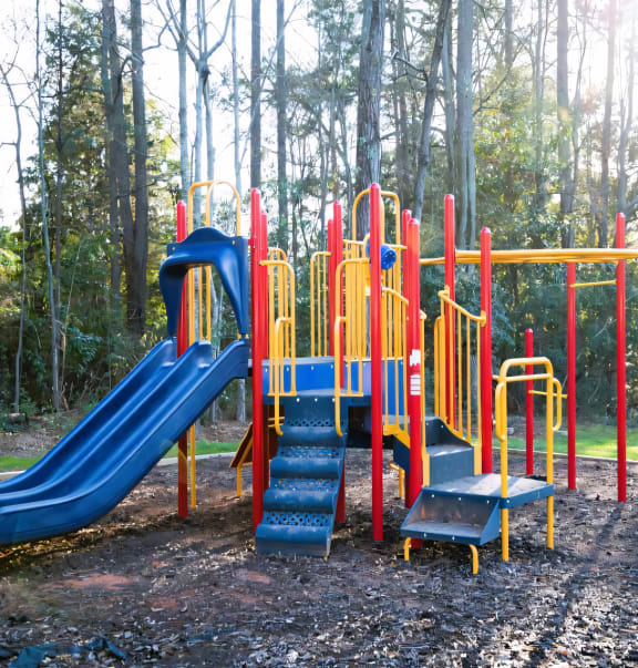 a playground with slides and a picnic table