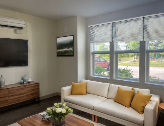 an empty living room with wood floors and a window
