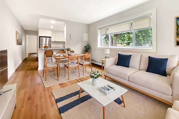 A living room with a white couch and a coffee table.