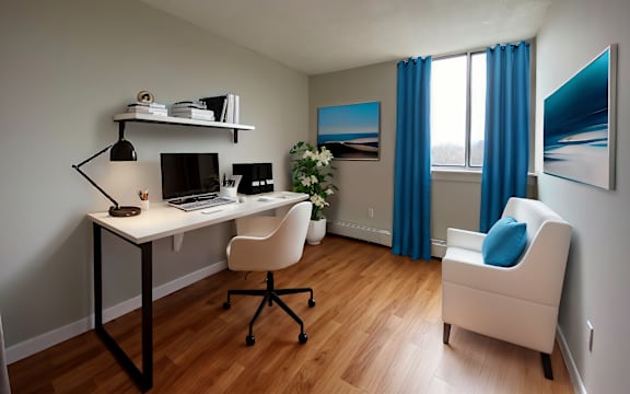 A room with a desk, chair, and a painting on the wall.
