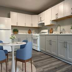 a kitchen with white appliances and wooden cabinets and a dining table at The Langston Views, Washington, DC, 20020