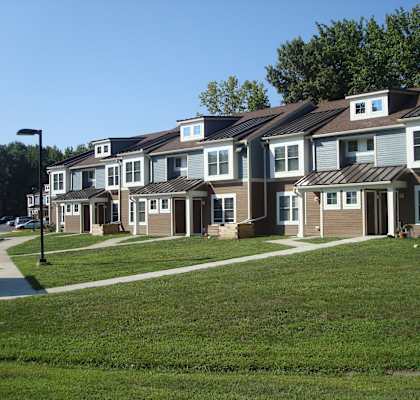 a row of houses on a grassy hill