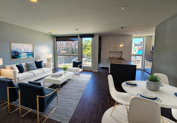 Open-concept living room at Highpoint Lakeview on Sheffield in Chicago with floor-to-ceiling windows and balcony access