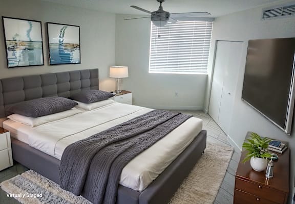a bedroom with a large bed and a ceiling fan at Meridian Point at Goulds Station in Miami, FL, 33170