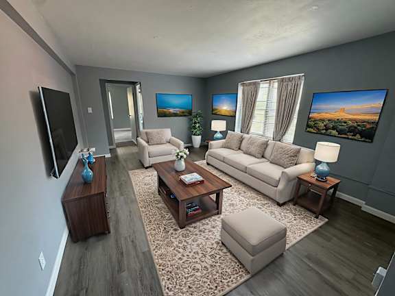 A kitchen with a bar stool and a couch.