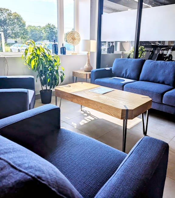 a living room with blue couches and a coffee table