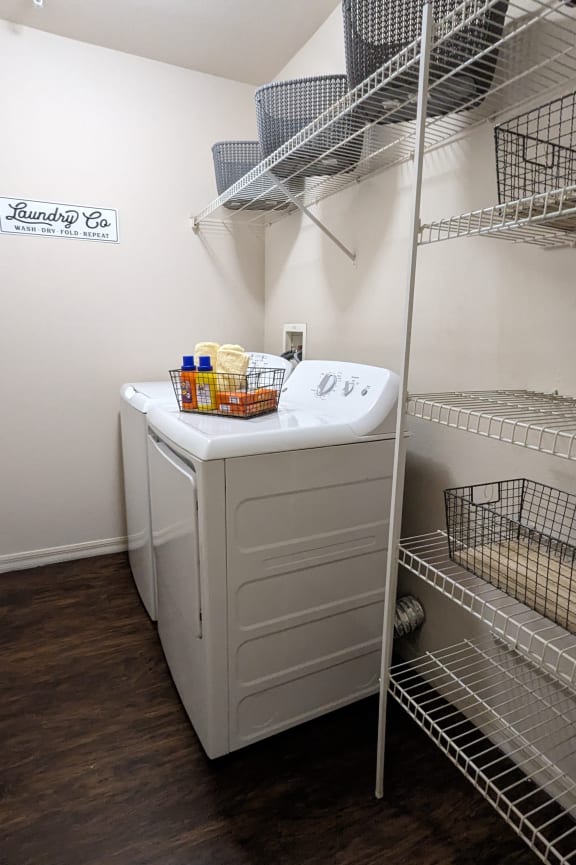 a walk in closet with a washer and dryer in it and a shelf at Tivoli Apartments of Orlando, Oviedo, 32765