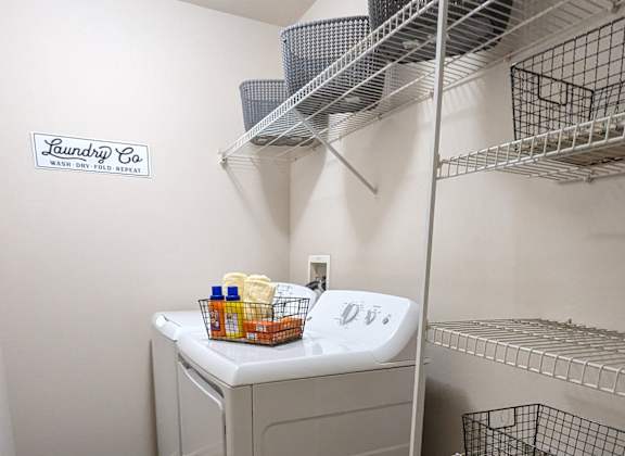 a walk in closet with a washer and dryer in it and a shelf at Tivoli Apartments of Orlando, Oviedo, Florida