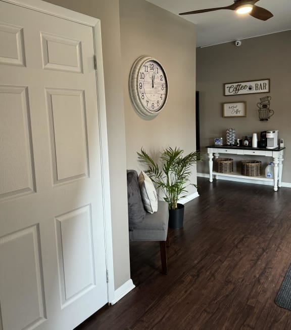 a living room with a chair and a clock on the wall