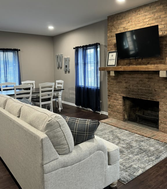 a living room with a couch and a table and a fireplace