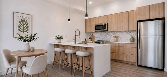 A kitchen with wooden cabinets and a window overlooking a cityscape.