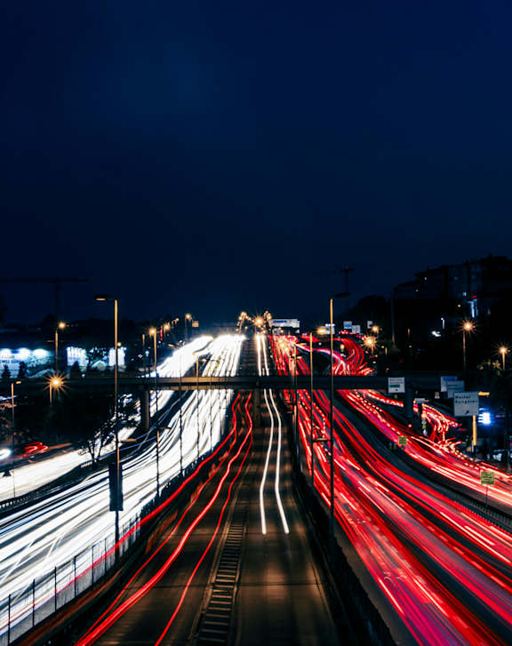 A long exposure shot of a busy highway at night at Casa de Luna Apartments, North Carolina, 27604