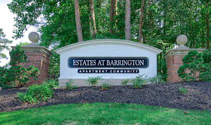 a sign for the estates in front of trees