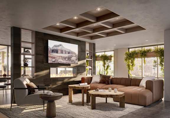 A modern living room with a large screen on the wall.