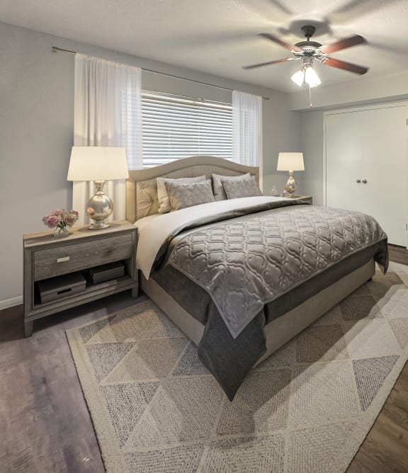 a bedroom with a bed and a ceiling fan