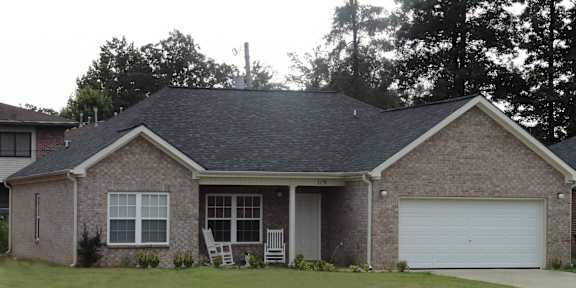 a house with a lawn and a white garage door