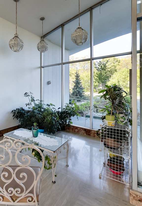 a living room with a table and chairs and a large window