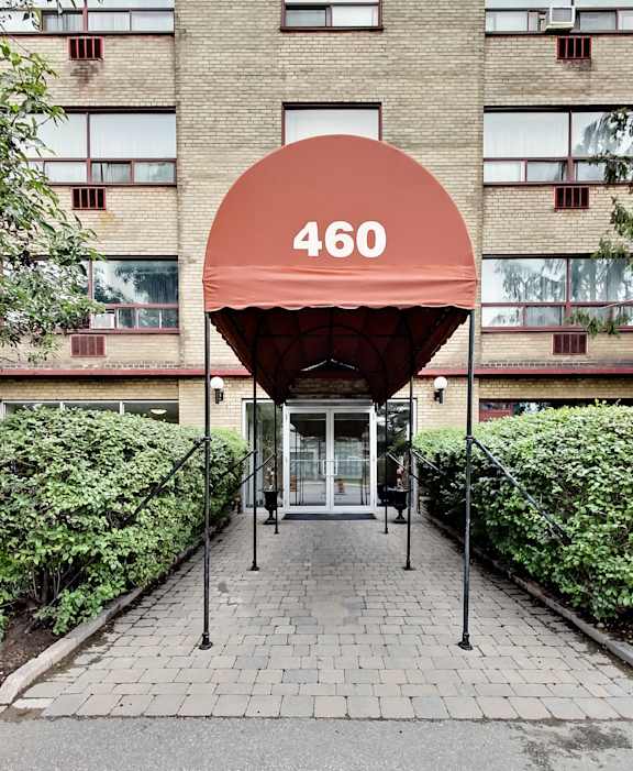 the building where the hotel is located has a red awning over the entrance