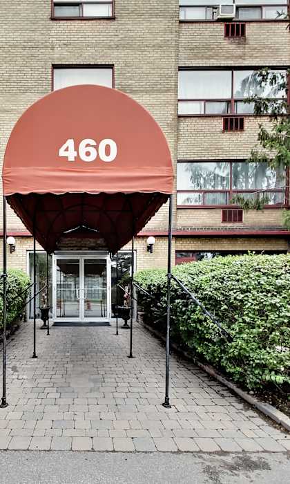 the building where the hotel is located has a red awning over the entrance