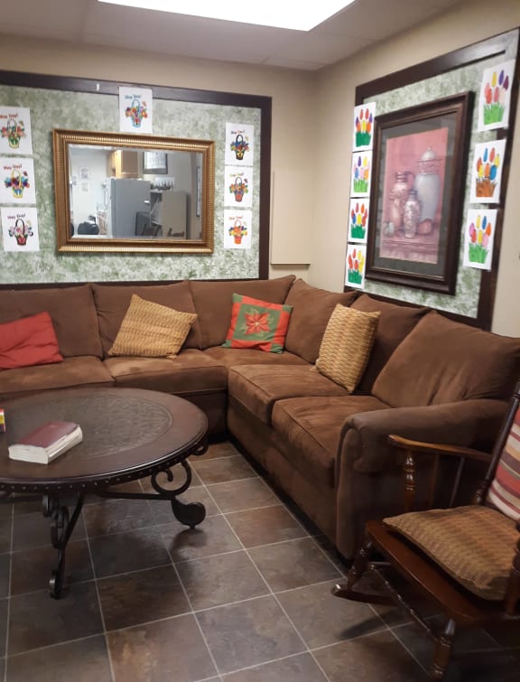 a living room with a brown couch and a table