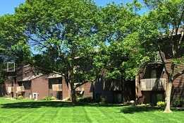 A grassy area in front of apartment buildings.