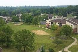 A residential area with houses and green lawns.